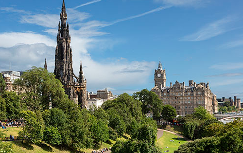 View of Edinburgh skyline with historic buildings and green parkland